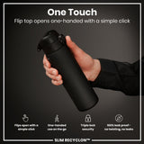 A black water bottle is held; its flip top opens one-handed via a simple click. The background is dark grey. 
