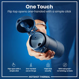 A dark-blue thermos; a hand opens its flip top; against a blue background. 